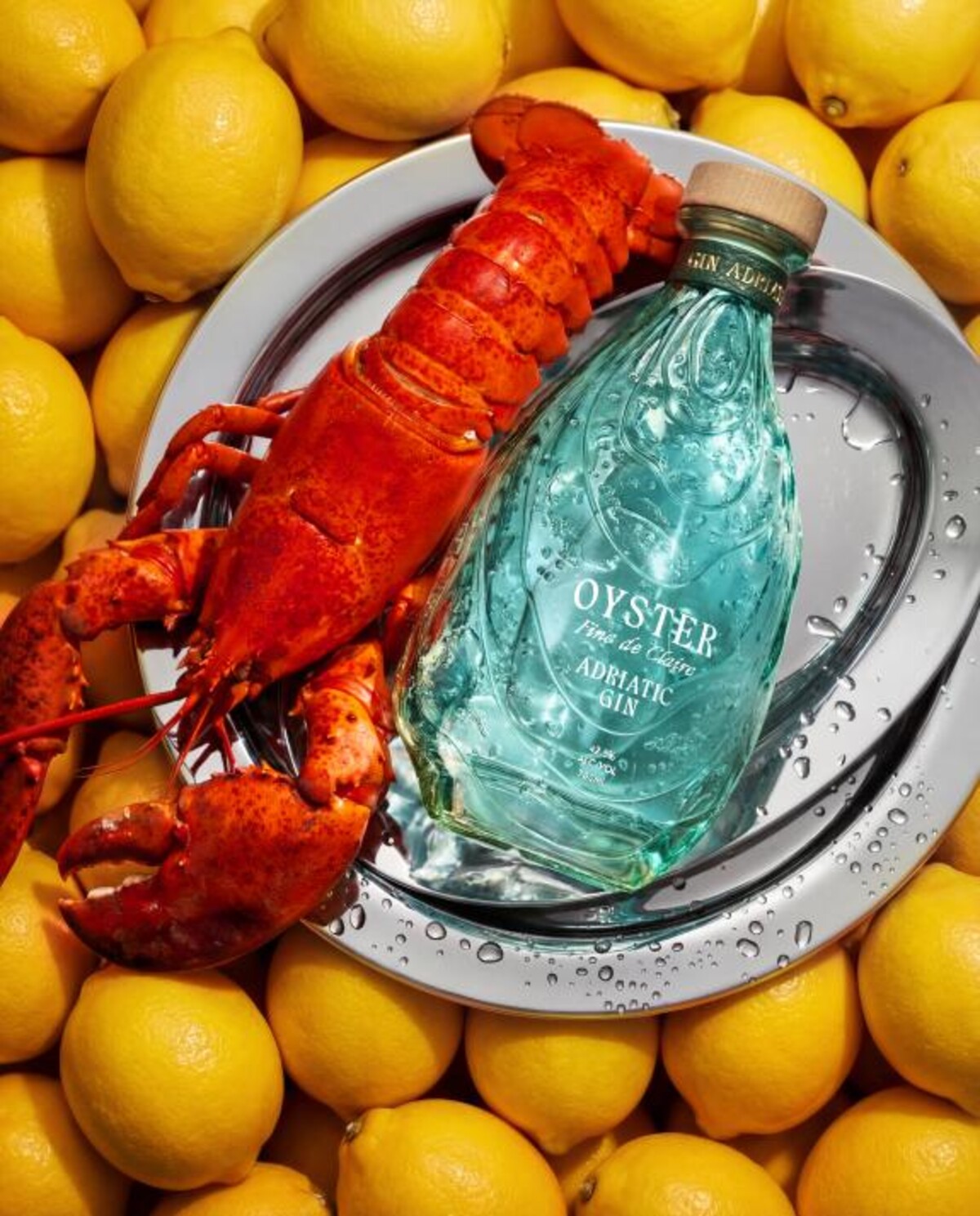 Oyster Gin bottle with lobster and lemons